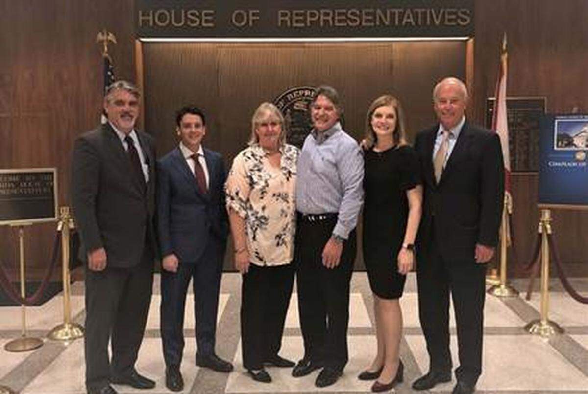Attorneys David Bianchi, Michael Levine and Stephen Cain of Miami firm Stewart Tilghman Fox Bianchi & Cain stand alongside Kathy Mears, chief legislative affairs officer for Florida State University and Tom and Sandy Coffey, parents of Andrew Coffey, an FSU student who died during a fraternity hazing event in November 2017. They are pictured here on March 11, 2019, when the House passed the Andrew’s Law bill.
