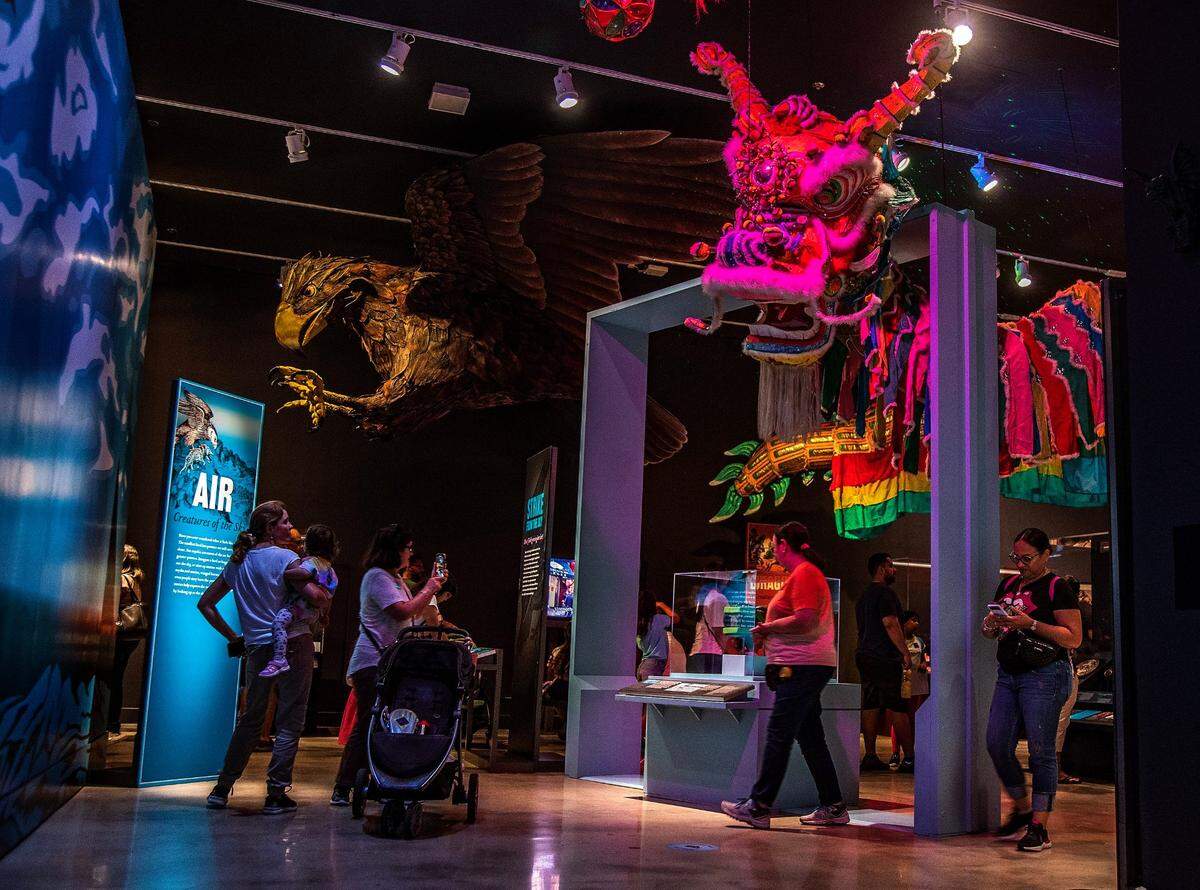 Visitors look at a giant model of a mythical Roc (left) and a a 120-foot-long Chinese parade dragon, used in New York City’s Chinatown to perform the traditional dragon dance at the Lunar New Year, part of the “Mythic Creatures: Dragons, Unicorns & Mermaids”, exhibition on display at the HistoryMiami Museum, The exhibition opening on July 8th, traces the natural and cultural roots of some of the world’s most enduring mythological creatures from Asia, Europe, the Americas, and beyond, and even how Miamians embrace their own mythic fantasies. Organized by theAmerican Museum of Natural History in New York, on Saturday, July 08, 2023.
