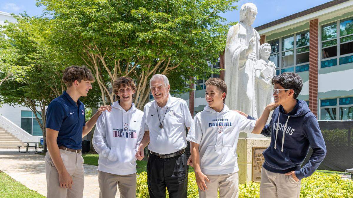 Brother Kevin Handibode, center, with Freshmen Luca Reyes, Maverick Mitchell, Garret Gus Gandarillas, and Mason More standing left to right at Christopher Columbus High School on Friday, May 22, 2026 in Miami, Fla.