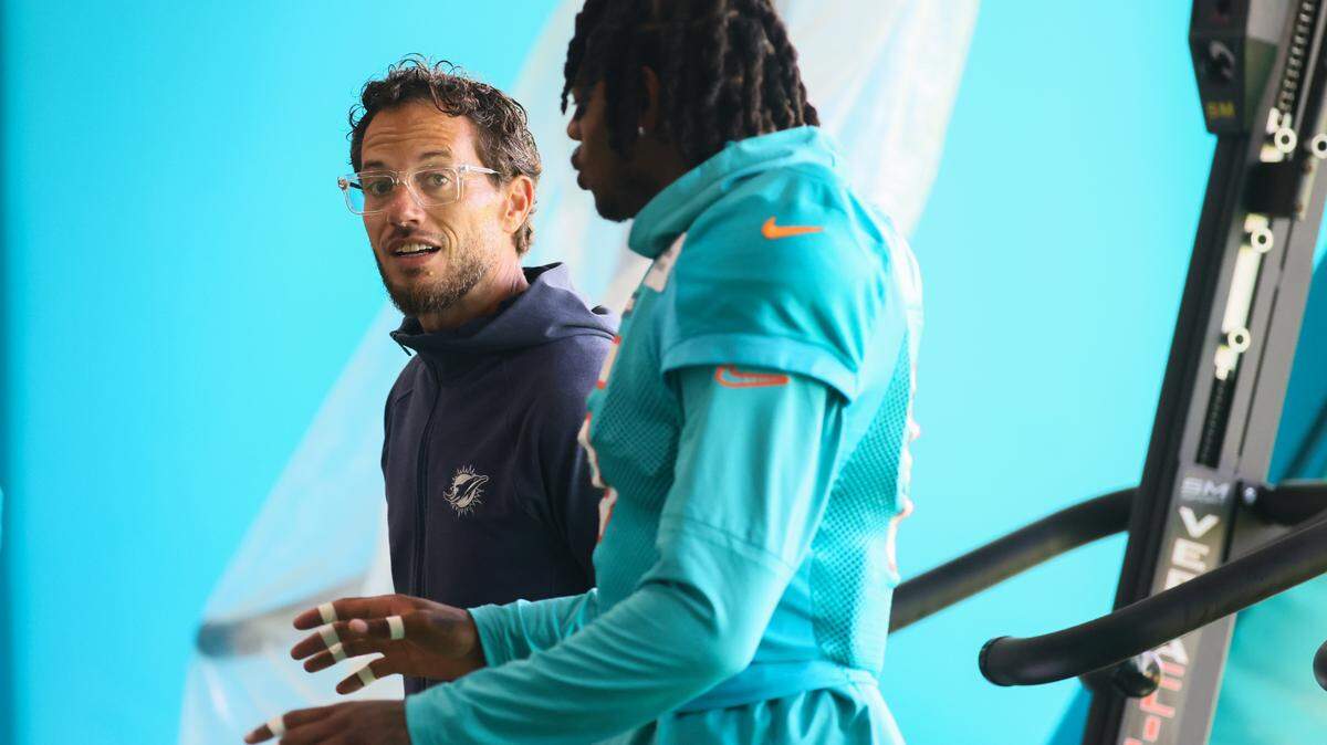 Miami Dolphins head coach Mike McDaniel talks to cornerback Jalen Ramsey (5) during training camp at Baptist Health Training Complex in Miami Gardens, Florida, on Tuesday, August 20, 2024.