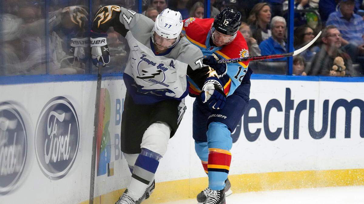 Florida Panthers center Eric Staal (12) checks Tampa Bay Lightning defenseman Victor Hedman (77) into the dasher during the first period of an NHL hockey game Saturday, Dec. 10, 2022, in Tampa, Fla. (AP Photo/Chris O’Meara)