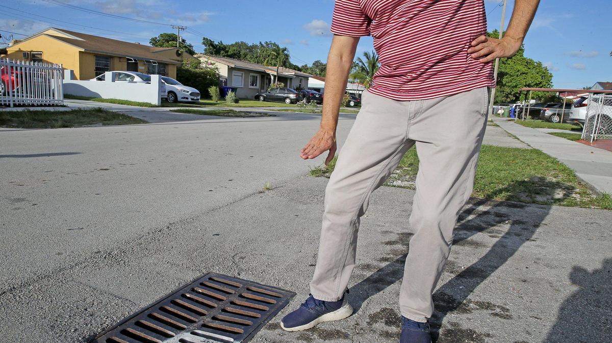 What needs fixing in DIstrict 4: A Flagami resident shows how high the water rises during a strong rains near a storm drain.
