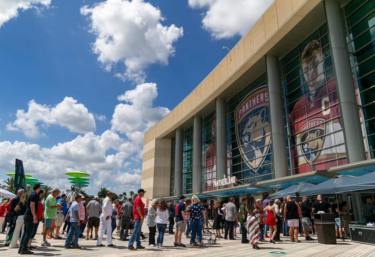 People arrive to the American Freedom Tour at the FLA Live Arena in Sunrise, Florida on Saturday, March 19, 2022. Former President Donald Trump is scheduled to speak at the event.