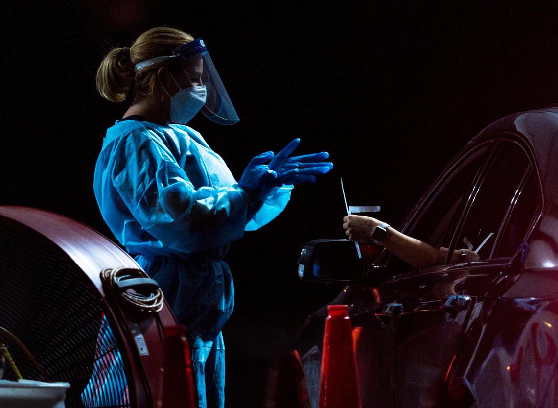 A medical professional administers a nasal swab to a person at the Tropical Park Nomi Health COVID-19 Testing Location in Miami, Florida, on Thursday, January 5, 2023.