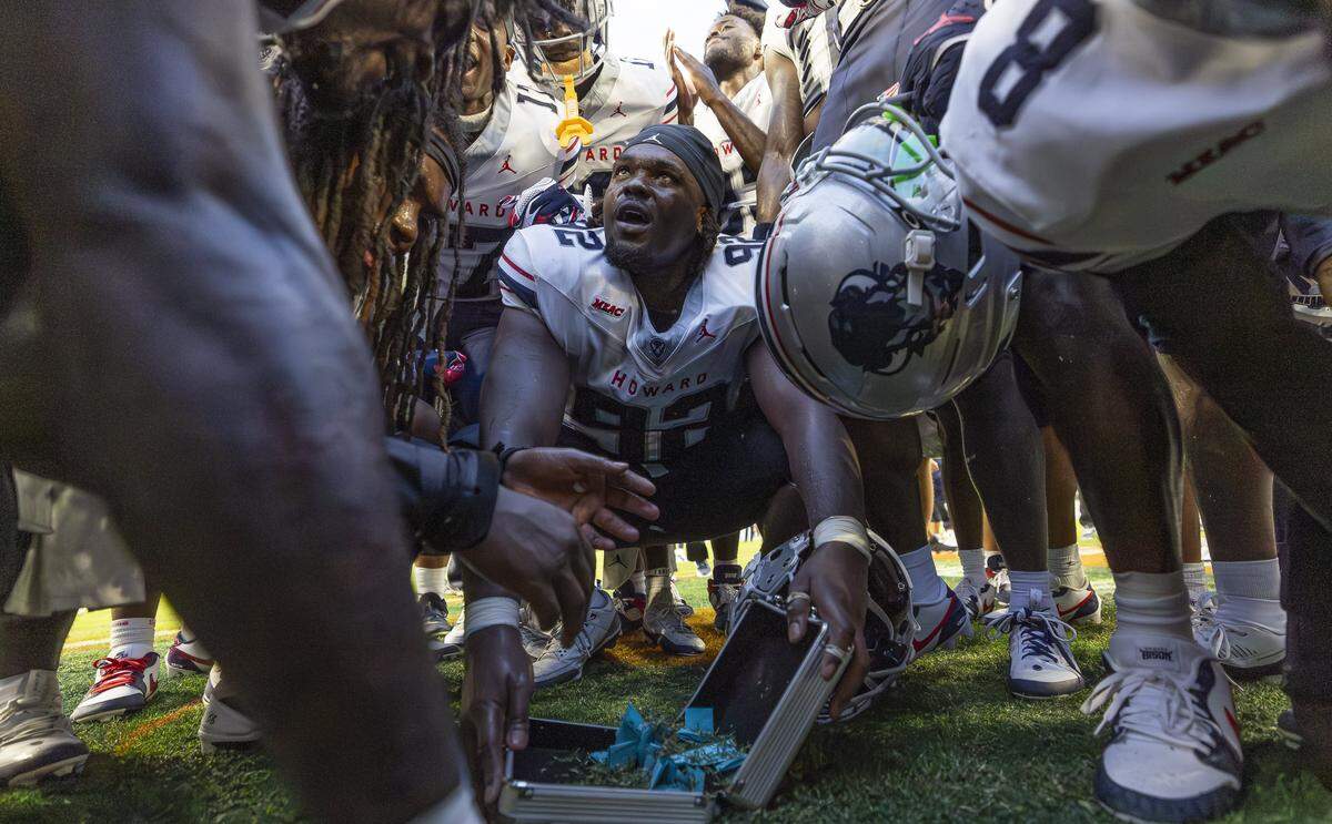 Florida A&M Rattlers defensive lineman Stantavious Smith (92) gathers grass in a small suitcase after his team defeated Florida A&M Rattlers in their Orange Blossom Classic football game at Hard Rock Stadium on Saturday, Aug. 30, 2025, in Miami Gardens, Fla.