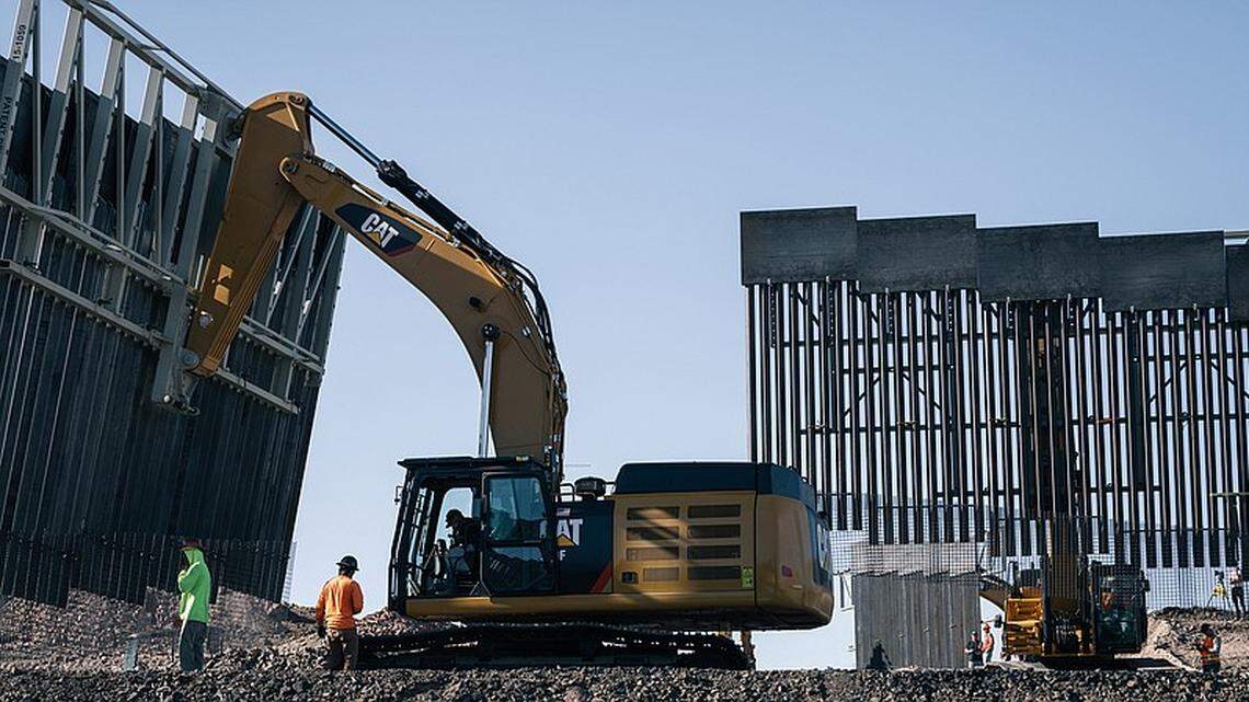 In 2019, workers move sections of President Trump’s border wall near where New Mexico, Texas and Mexico come together.