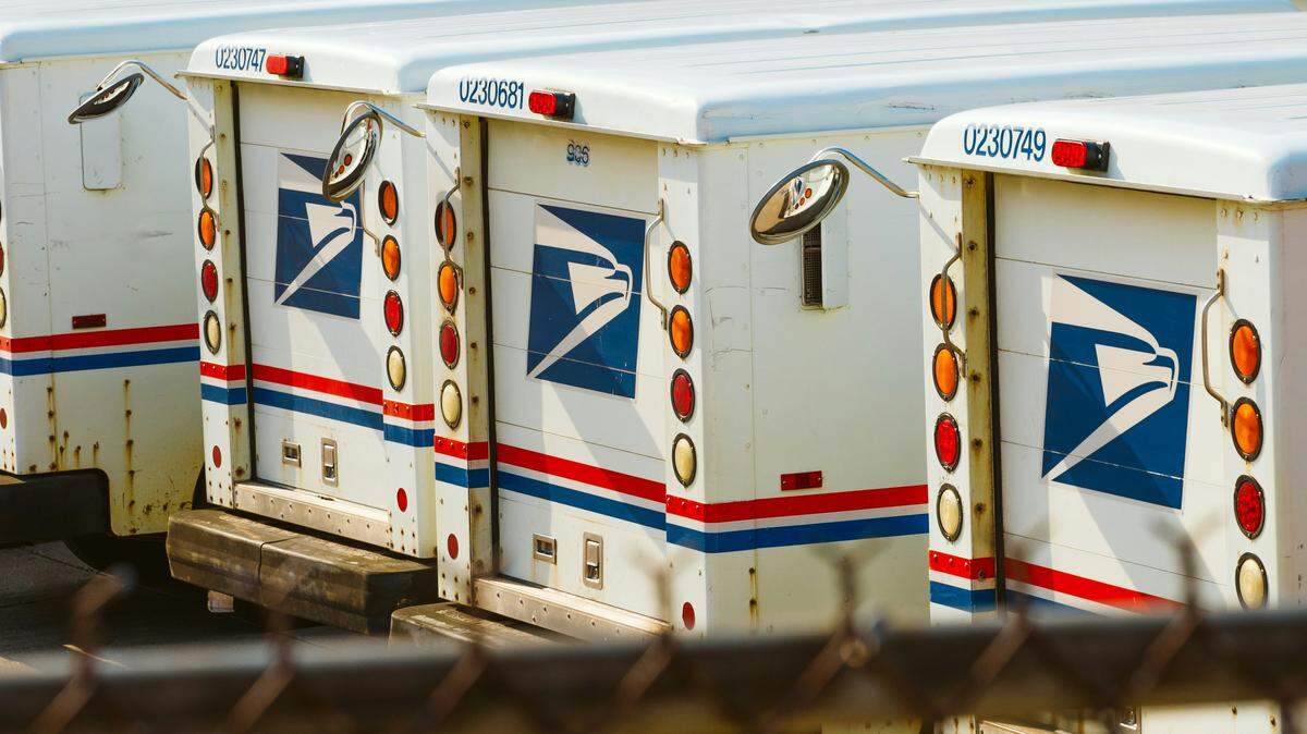 A former U.S. Postal Service employee has been sentenced to prison after federal prosecutors said he stole checks from the mail and then tried to flee the country.