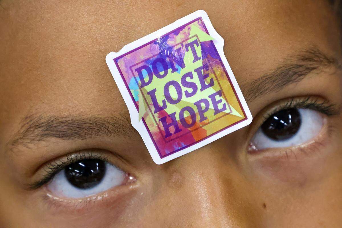 Jeremiah Rodriguez, 7, understands the assignment by placing a sticker on his forehead during goal setting workshop for thirty children under the age of 13 during the Amplify Community Resources' 4th Annual Back-to-School Youth Readiness Summit on Thursday, July 31, 2025, in Miami, Florida.