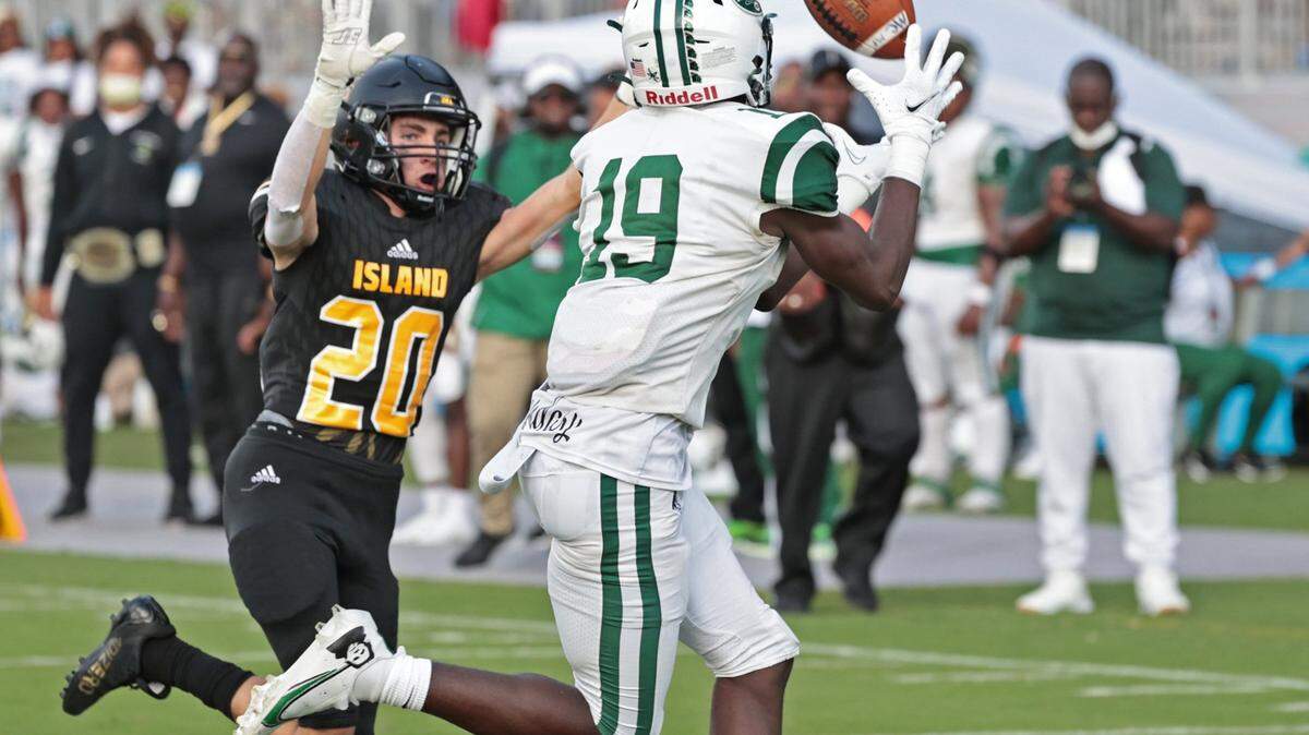 Miami Central High School wide receiver Isaac Hay scores on a pass reception in the third quarter as Merritt Island High Schools Avante Thomas defends in the FHSAA Class 5A State Championship at DRV PNK Stadium, in Fort Lauderdale on Friday, December 17, 2021.