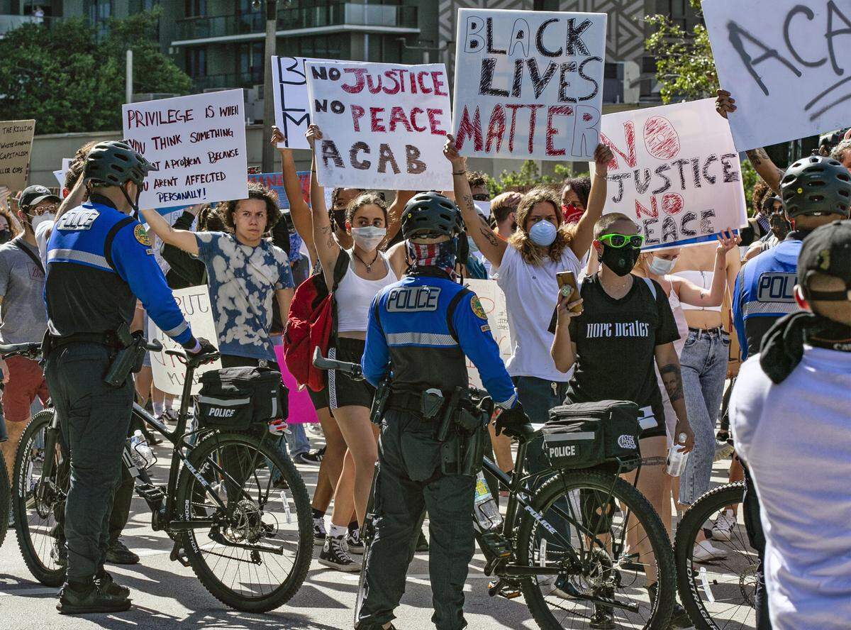 Miami police close off a street during a ‘Justice for George Floyd’ protest in downtown Miami on Saturday, May 30, 2020.