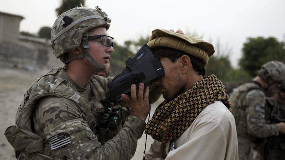 A U.S. Army soldier scans the irises of an Afghan civilian in 2012 as part of the military’s effort to collect biometric information from most of the Afghan population.