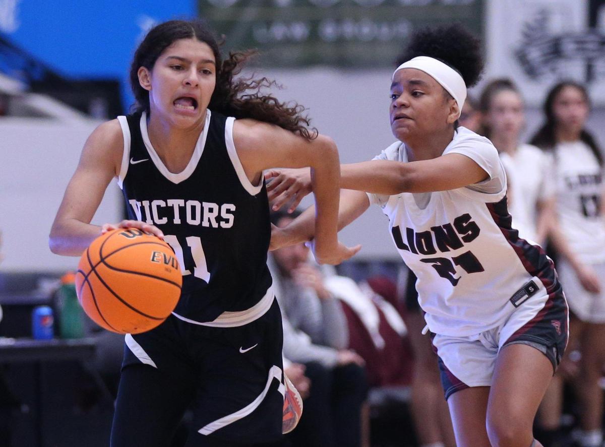 Miami Christians Enjulina Gonzalez (11) is chased by Jazzmin Gardner (21) in the Class 2A girls basketball state championship game at the RP Funding Center in Lakeland on Saturday, February 26, 2022.
