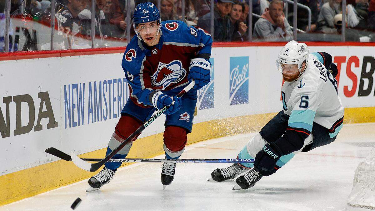 Apr 20, 2023; Denver, Colorado, USA; Colorado Avalanche center Evan Rodrigues (9) controls the puck ahead of Seattle Kraken defenseman Adam Larsson (6) in the second period in game two of the first round of the 2023 Stanley Cup Playoffs at Ball Arena. Mandatory Credit: Isaiah J. Downing-USA TODAY Sports