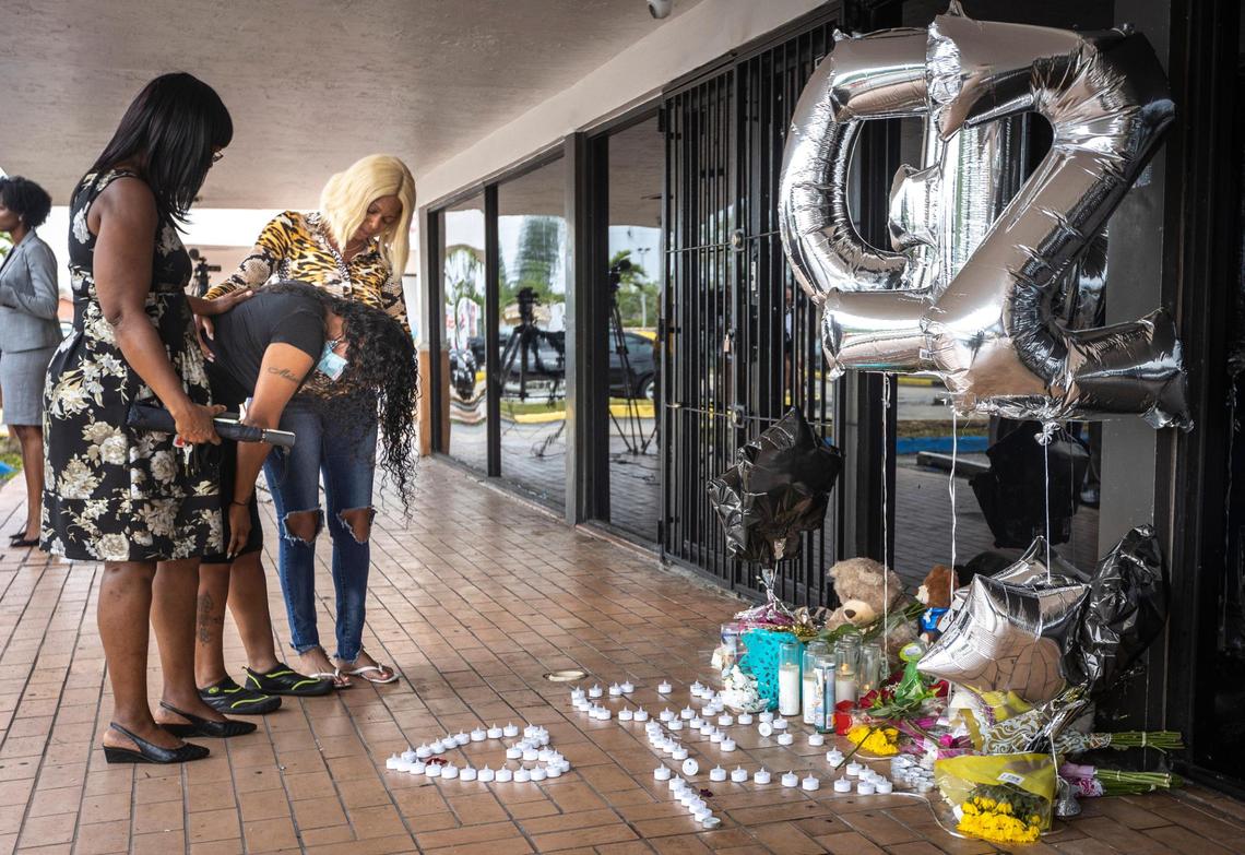 Melanie Brutan, leaning over, mother of Desmond Owens, who was killed at the shooting at El Mula Banquet Hall, grieves in front of a makeshift memorial at El Mula Banquet Hall on June 3, 2021, as Annette Jones, left, and Schkena Brutan comfort her.