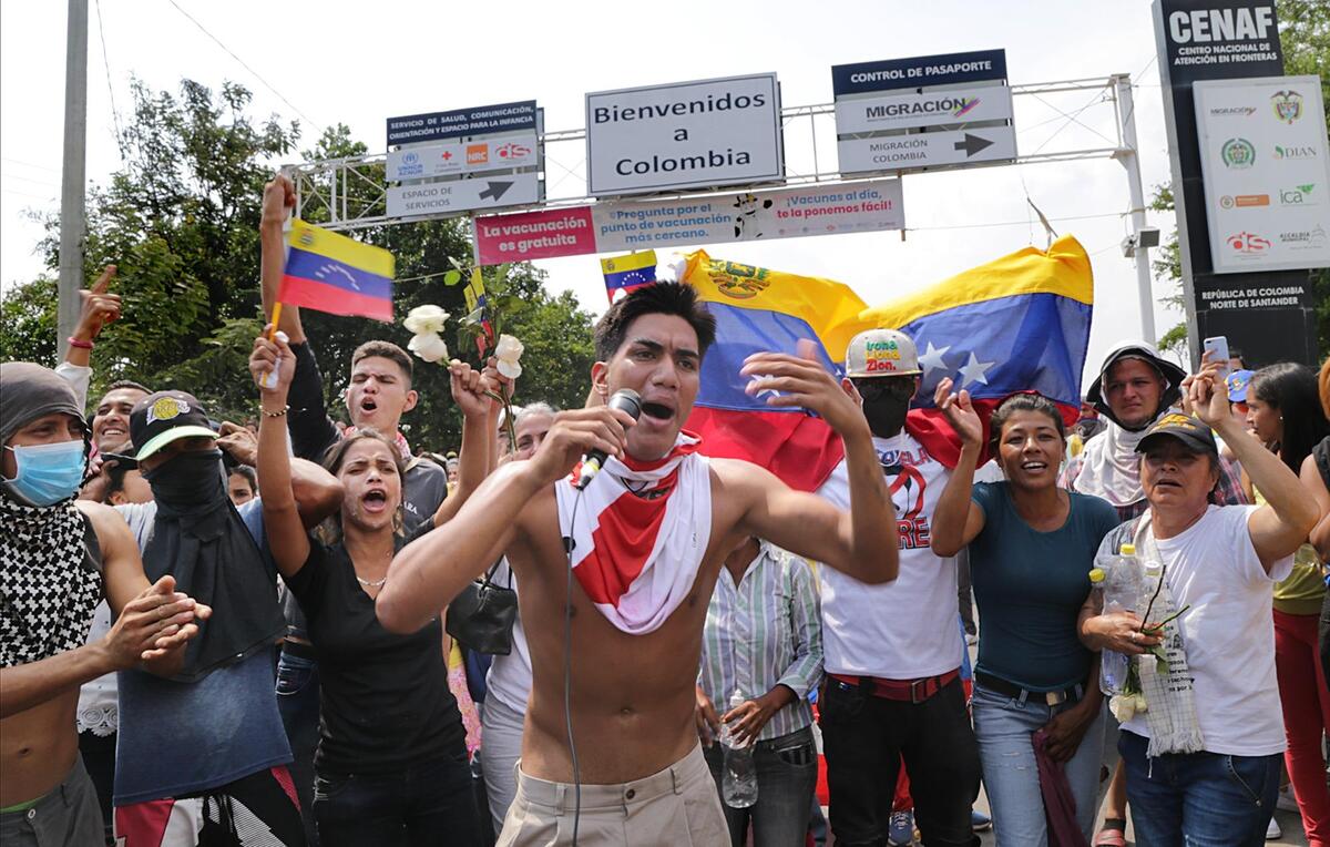Protesters react on the Colombian side of the border as they get attacked by the Maduro’s military and members of los Colectivos, while attempting to move in several trucks loaded with aid donated for their country through the Simon Bolivar International bridge on the Colombian side as interim President Juan Guaido Guaido and his supporters were hoping to move humanitarian aid into Venezuela Saturday against the wishes of leader Nicolas Maduro on February 23, 2019.
