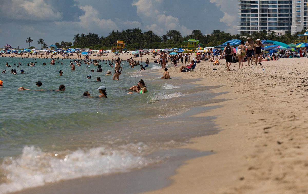 People enjoy the sargassum free beach on Monday, July 3, 2023, in Miami Beach.