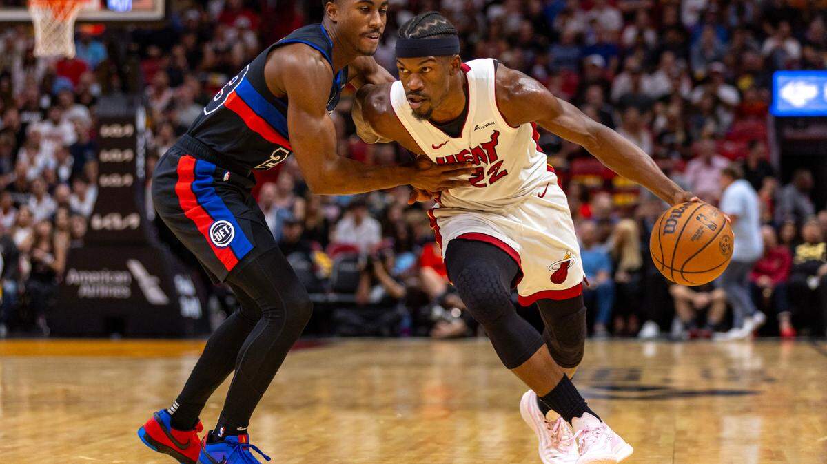 Miami Heat forward Jimmy Butler (22) drives on Detroit Pistons guard Jaden Ivey (23) during the first quarter of an NBA game at Kaseya Center in Miami, Florida, on Wednesday, October 25, 2023.