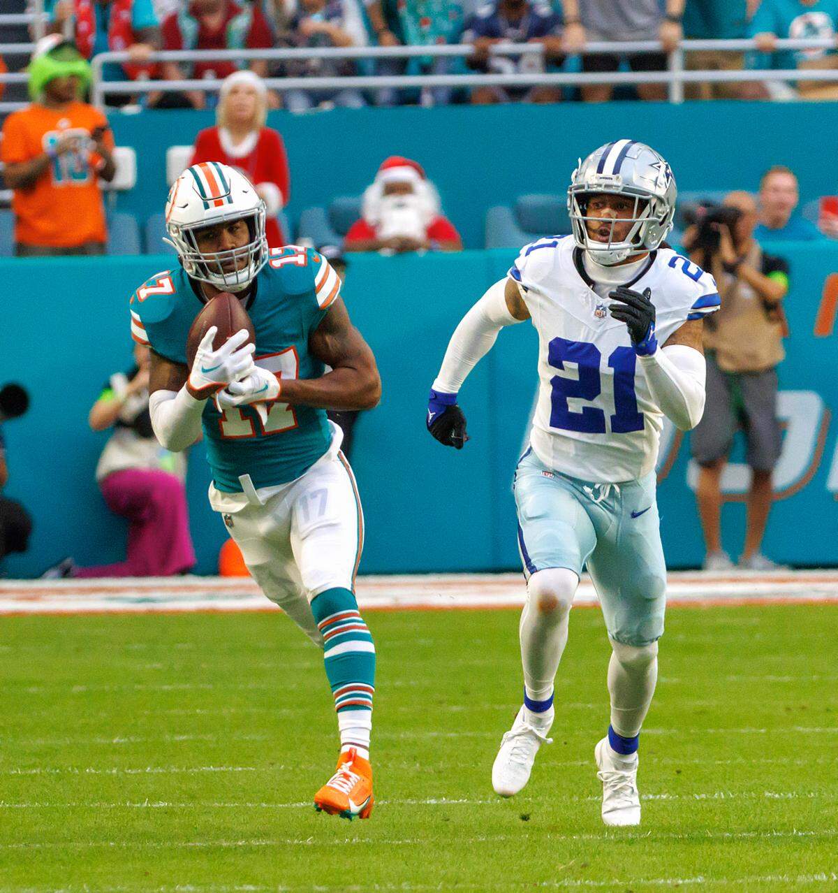 Miami Dolphins wide receiver Jaylen Waddle (17) catches a pass as Dallas Cowboys cornerback Stephon Gilmore (21) defends during first quarter of an NFL football game at Hard Rock Stadium on Sunday, Dec. 24, 2023 in Miami Gardens, Fl.