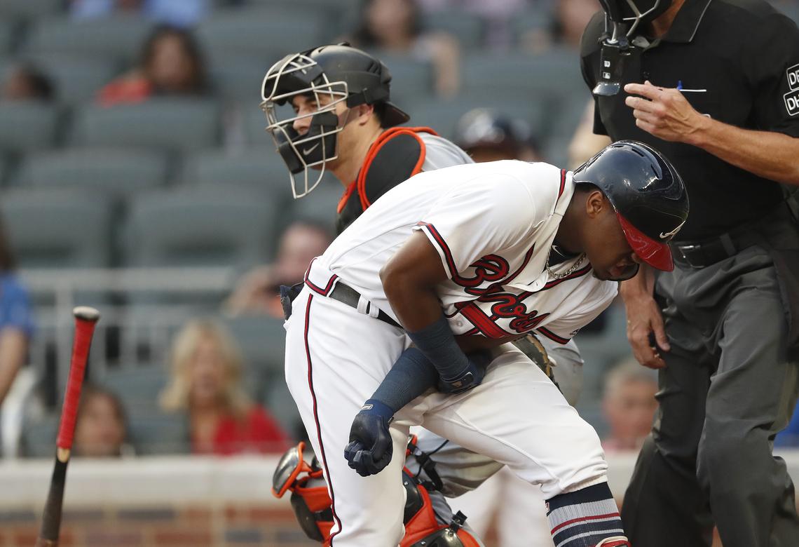 Atlanta Braves’ Ronald Acuna Jr. (13) reacts after being hit by a pitch from Miami Marlins’ Jose Urena during the first inning of a baseball game Wednesday, Aug. 15, 2018, in Atlanta. Both dugouts emptied and Urena was ejected. (AP Photo/John Bazemore)