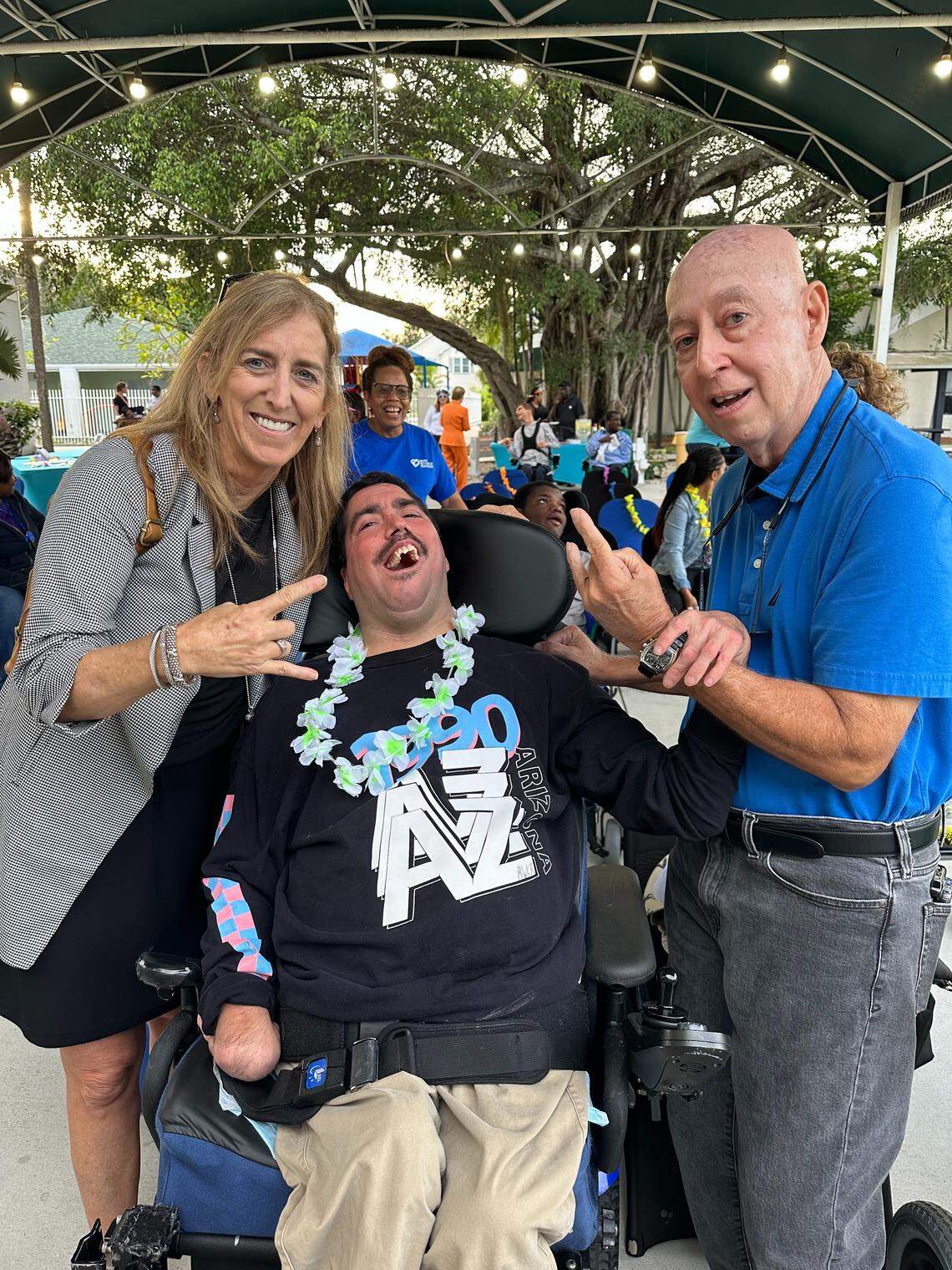 From left, Patricia Murphy, CEO of the Ann Storck Center in Fort Lauderdale, greets Alek Rivera and his father Carlos Rivera. Alek died last November after living at the center for 29 years. His father credits the center with allowing him to live his life to his full potential.  