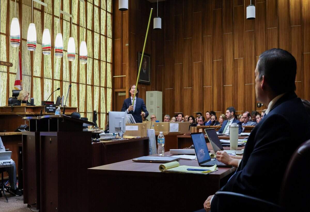 Defense attorney Howard Srebnick uses a measuring tape to simulate the height of markers as he delivered his closing arguments on Monday, June 22, 2026, in Courtroom 4-1 at the Richard E. Gerstein Justice Building in Miami, Florida. He argued that Marker 15 was shorter than the rest of the markers in the channel. Srebnick urged the jury to find George Pino not guilty of manslaughter and vessel homicide charges linked to boat crash that killed Lucy Fernandez.
