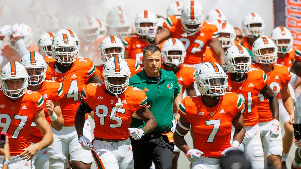 Miami Hurricanes head coach Mario Cristobal take the field with the team during the first quarter of an NCAA non conference game at Hard Rock Stadium on Saturday, September 10, 2022 in Miami Gardens, Florida.