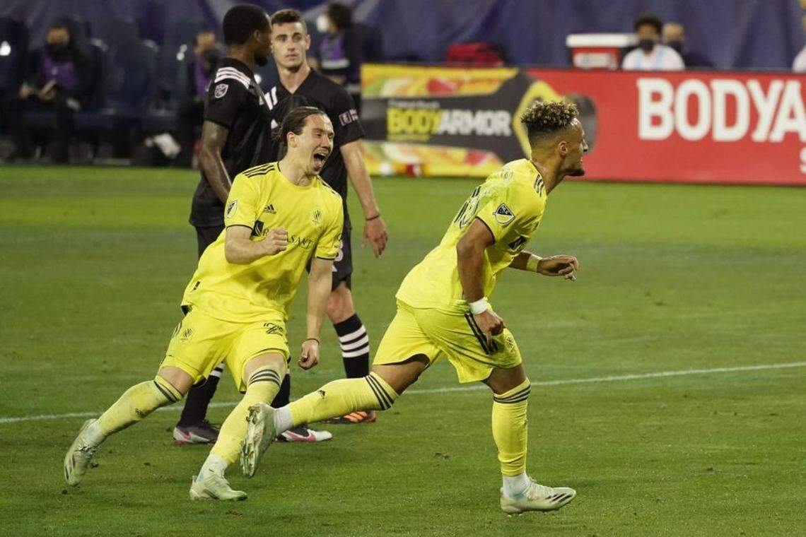 Nashville SC midfielder Hany Mukhtar, right, celebrates with Alex Muyl (29) after Mukhtar scored a goal against Inter Miami on a penalty kick during the first half of an MLS soccer playoff match Friday, Nov. 20, 2020, in Nashville, Tenn. (AP Photo/Mark Humphrey)