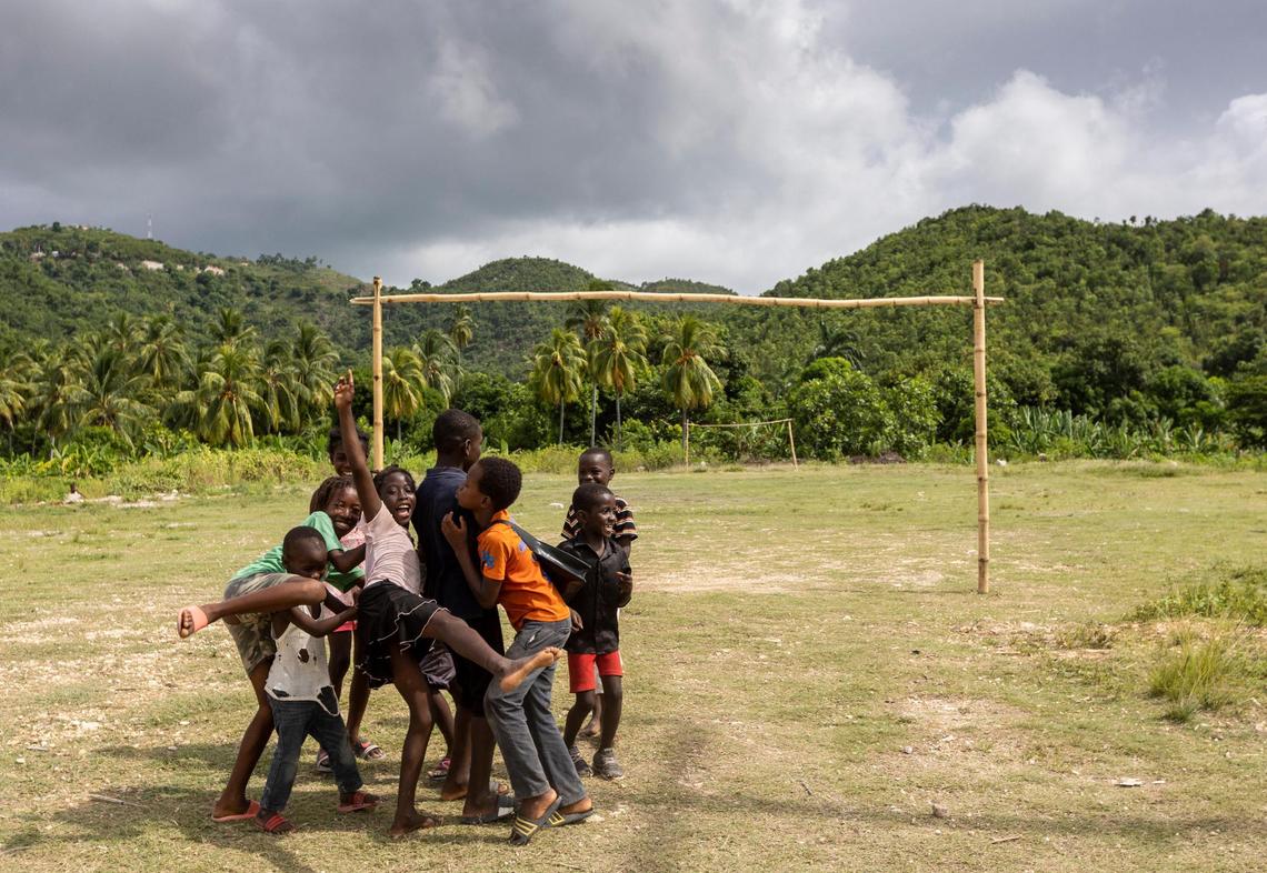 Kids play near a soccer field in Corail, Haiti.
