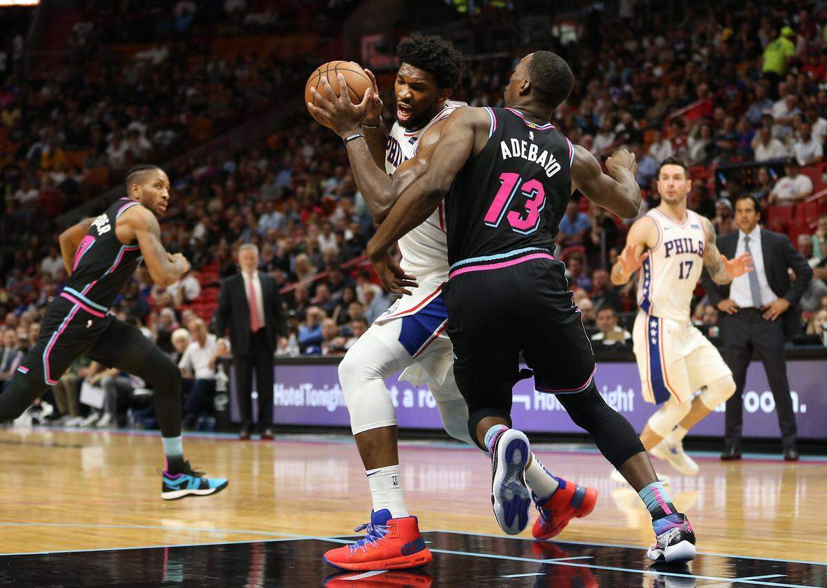 Philadelphia 76ers center Joel Embiid (21) drives past Miami Heat center Bam Adebayo (13) as the Miami Heat host the Philadelphia 76ers on Monday, November 12, 2018.