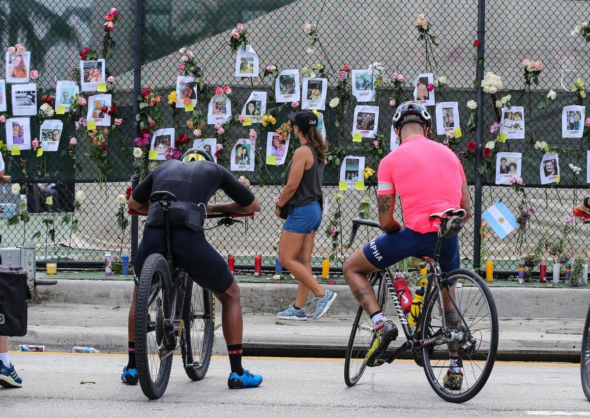 A memorial for the victims is displayed one block west of the 12-story ocean front Champlain Towers South, that partially collapsed early Thursday morning in the town of Surfside, as a massive search-and-rescue effort with dozens of rescue crews from across Miami-Dade and Broward counties continue to work on Saturday, June 26, 2021.