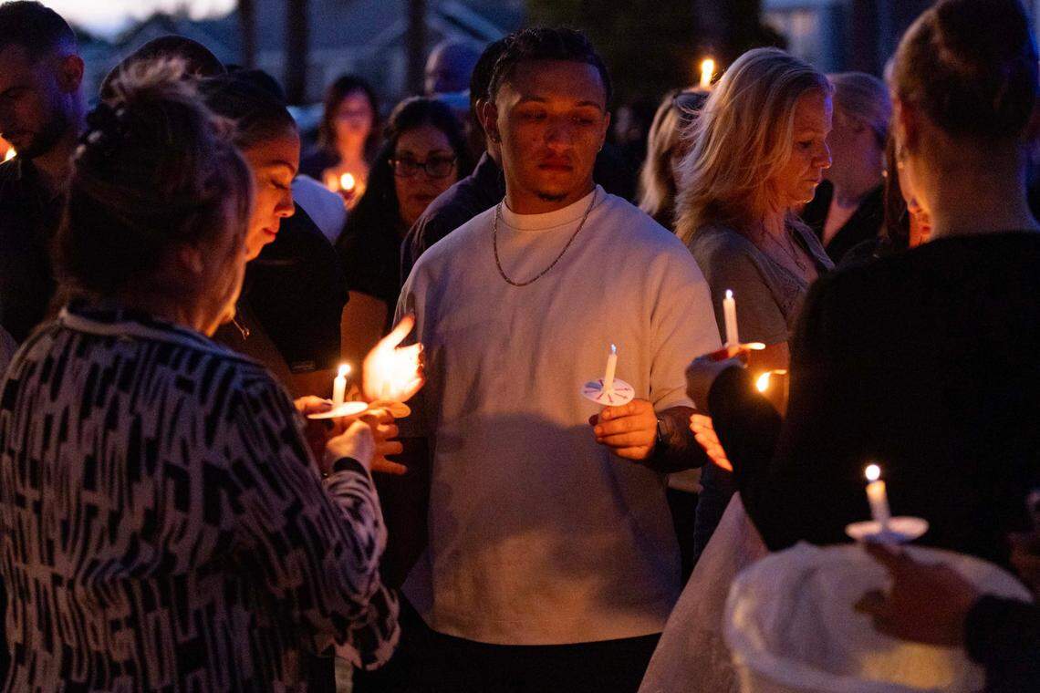 Cousins of Andrew Ferrin mourn during a candlelight vigil inside the Plum Bay community on Sunday, February 23, 2025, in Tamarac, Florida.
