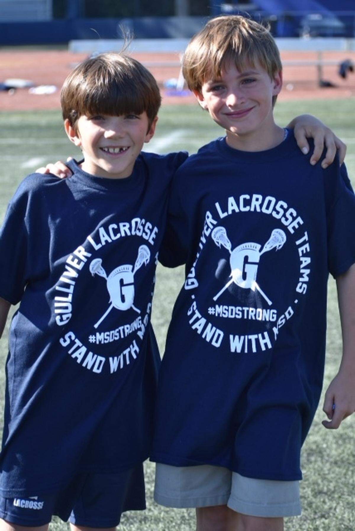 Gulliver Academy third graders Simon Perry and Miller Garfinkel attended the Gulliver Prep lacrosse game to show support for Marjory Stoneman Douglas High School students.