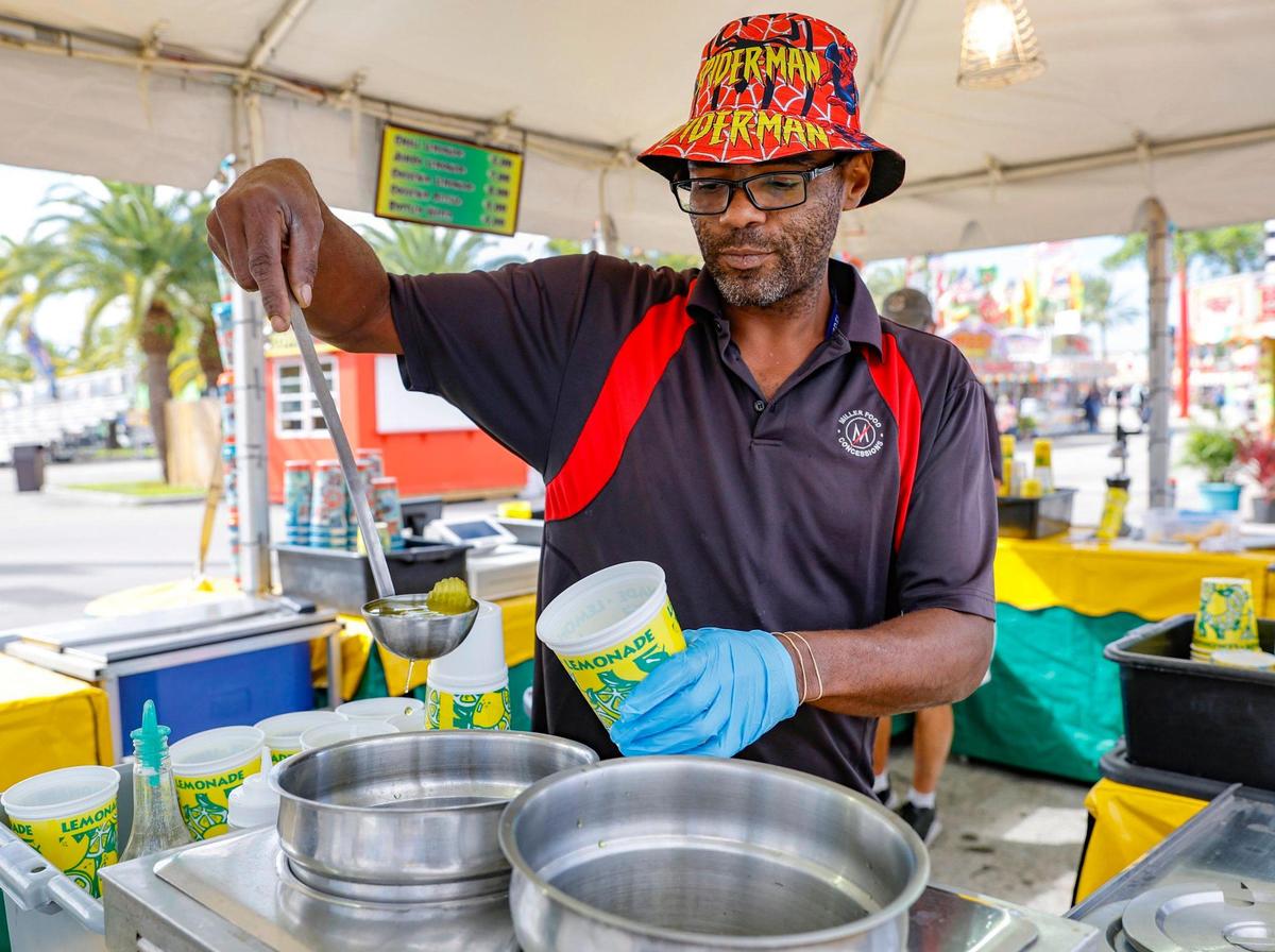 Jerrell Newsome serves pickle lemonade at the Miami-Dade County Fair & Exposition.