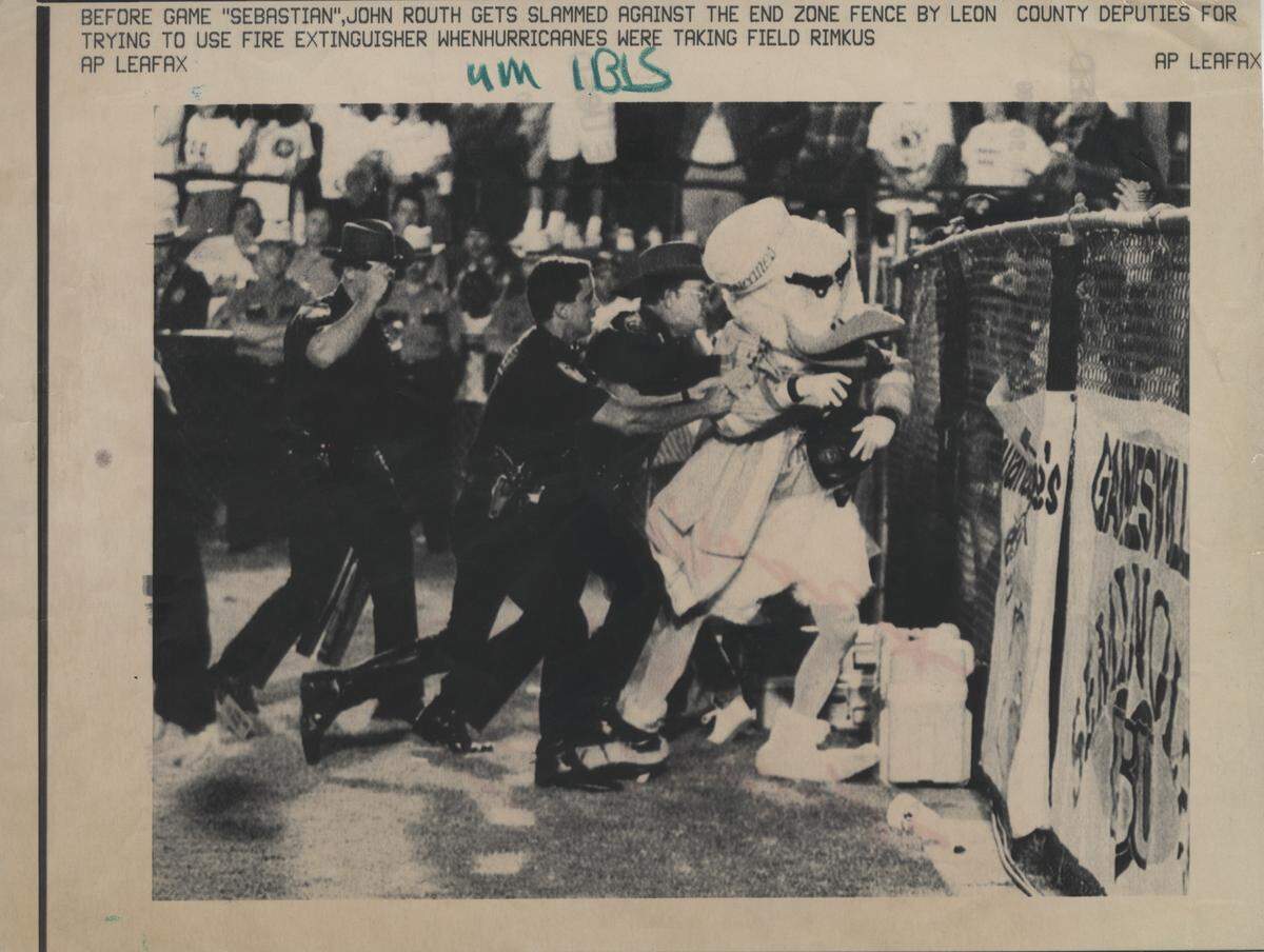 UM's Sebastian the Ibis (John Routh) is slammed against the fences by Leon County deputies after carrying a fire extinguisher near Renegade, Florida State's Appaloosa mascot, before the start of the UM-FSU game at Doak Campbell Stadium in Tallahassee.