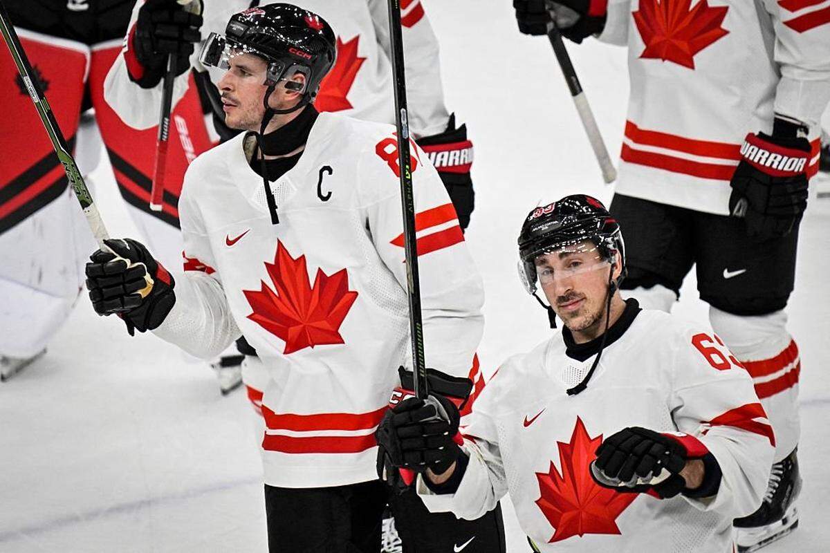 Canada's #87 Sidney Crosby (L) and Canada's #63 Brad Marchand celebrate at the end of the men's preliminary round Group A Ice Hockey match between Czech Republic and Canada at the Milano Santagiulia Ice Hockey Arena during the Milano Cortina 2026 Winter Olympic Games in Milan, on February 12, 2026. Canada wins 5 -0 against Czech Republic. (Photo by Alexander NEMENOV / AFP via Getty Images)