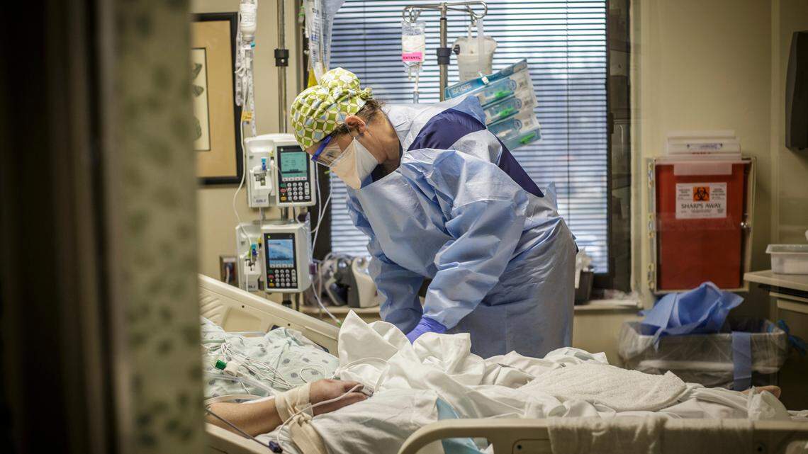 Sonya Morgan, a Registered Nurse, works with a COVID-19 positive patient inside the infectious disease unit (IDU) at Helen Keller Hospital, in Sheffield, Ala., Friday, Jan. 28, 2022. (Dan Busey/The TimesDaily via AP)