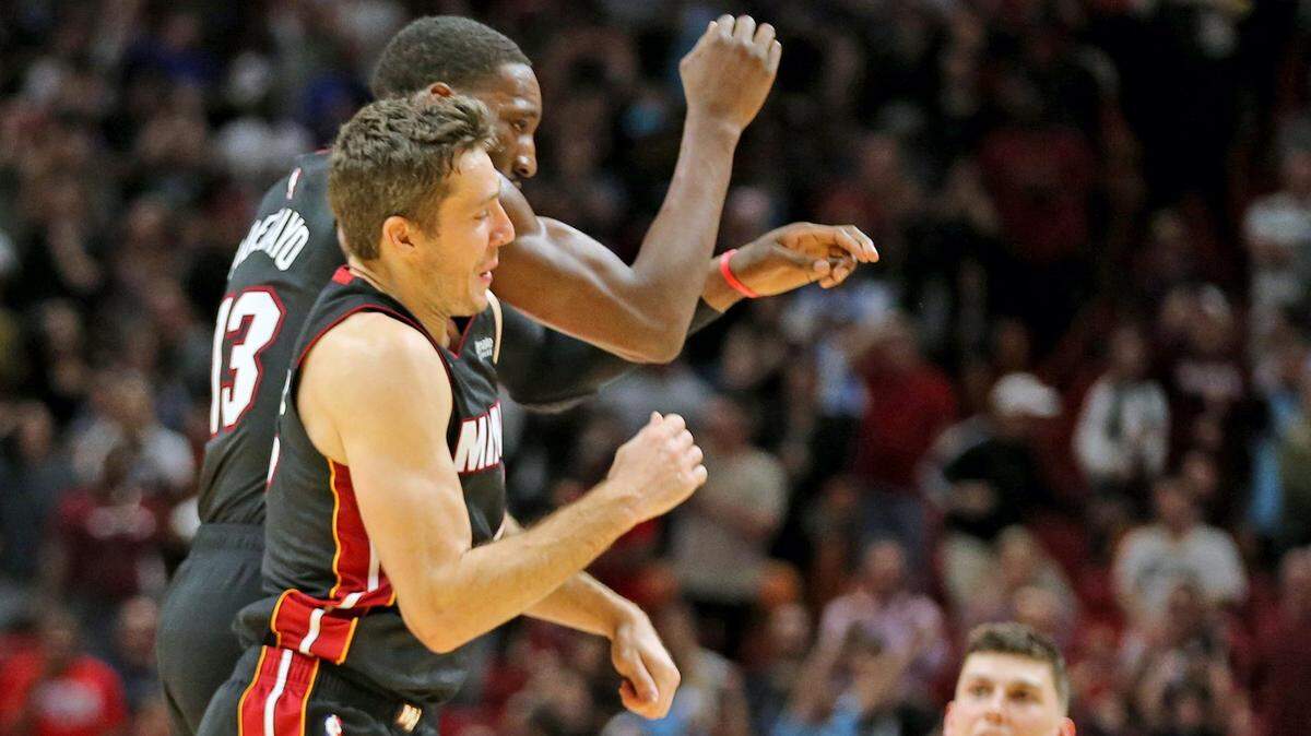 Miami Heat Goran Dragic (7) and Bam Adebayo (13) celebrate after scoring a points at the end of regulation to put the Heat into overtime with the Sacramento Kings at the AmericanAirlines Arena in Miami, Florida, Monday, January, 20, 2020.