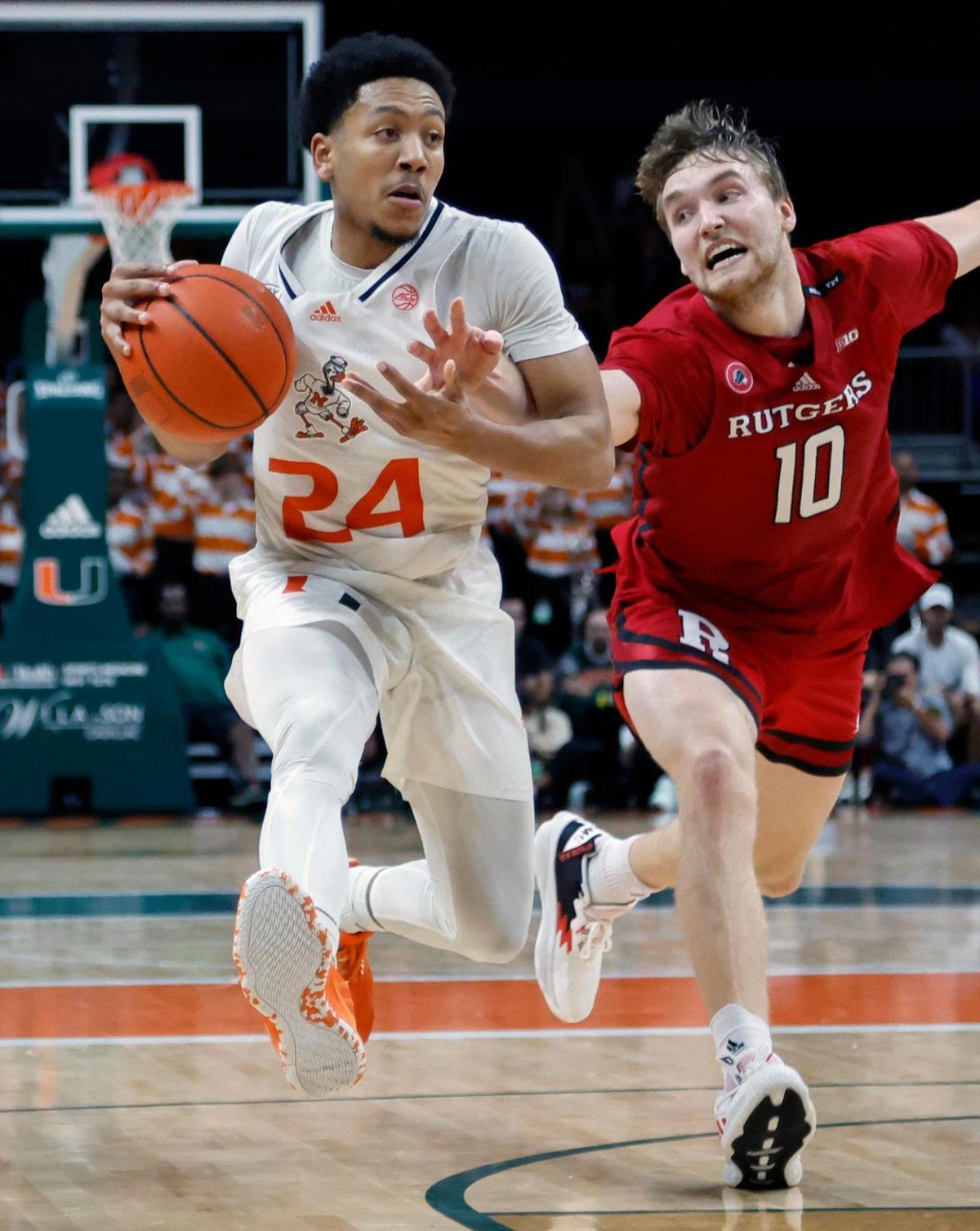 Miami Hurricanes guard Nijel Pack (24) drives to the basket as Rutgers Scarlet Knights guard Cam Spencer (10) defends in the second half at the Watsco Center in Coral Gables on Wednesday, November 30, 2022.
