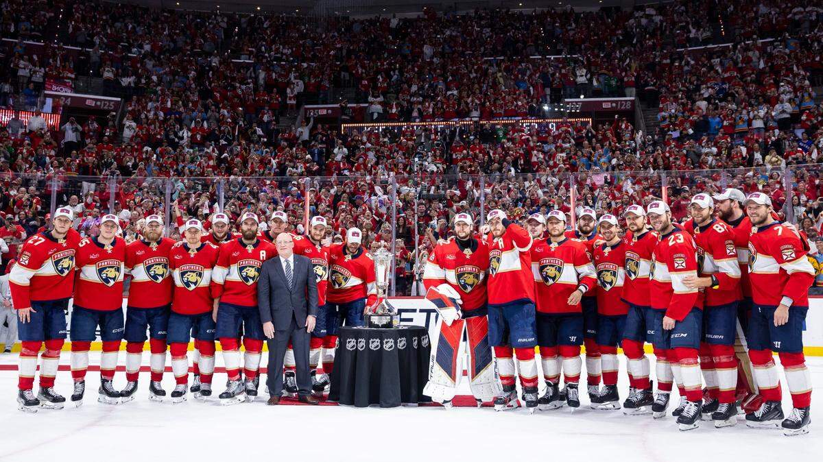 The Florida Panthers gather for a photo with Bill Daly, deputy commissioner of the NHL, and the Prince of Wales trophy after defeating the New York Rangers in Game 6 of the Eastern Conference finals of the NHL hockey Stanley Cup playoffs at the Amerant Bank Arena on Saturday, June 1, 2024, in Sunrise, Fla.