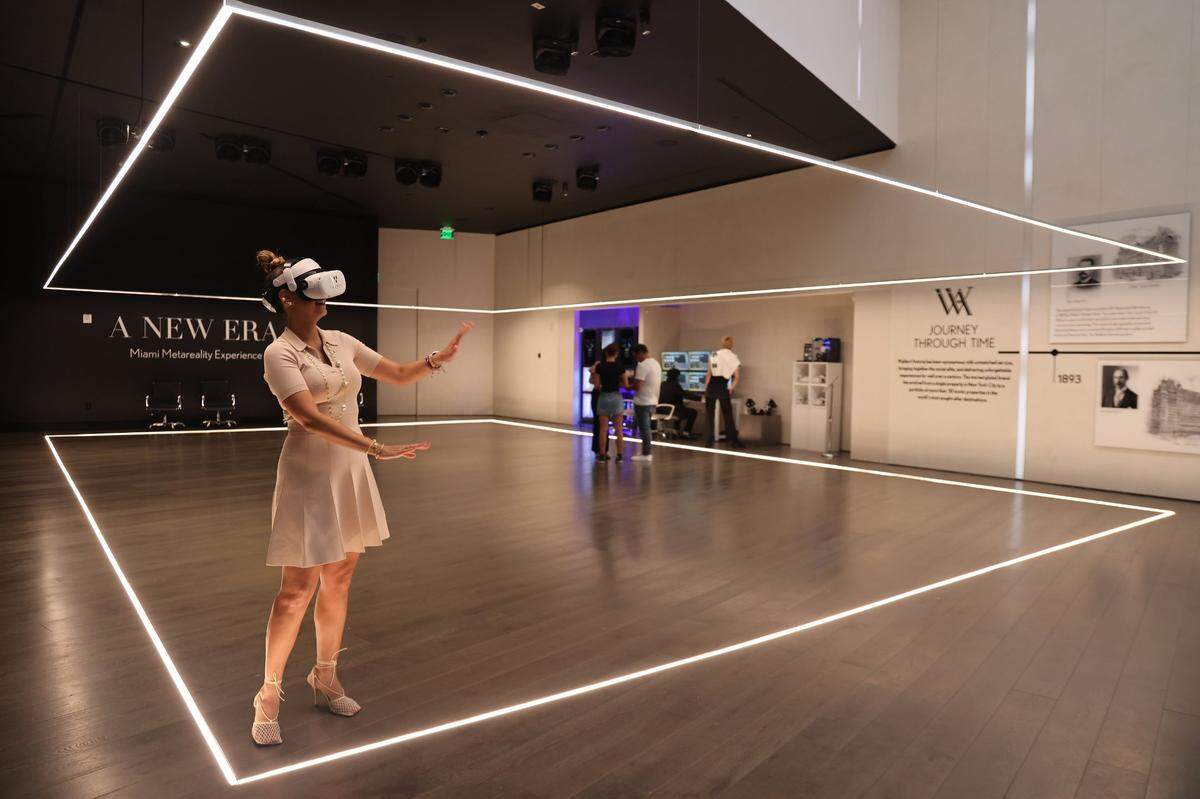Alejandra Castillo, vice president of sales for PMG Residential, takes a ‘virtual’ walk through Aug. 9, 2023 of the Waldorf Astoria 100-story high-rise being built in downtown Miami.