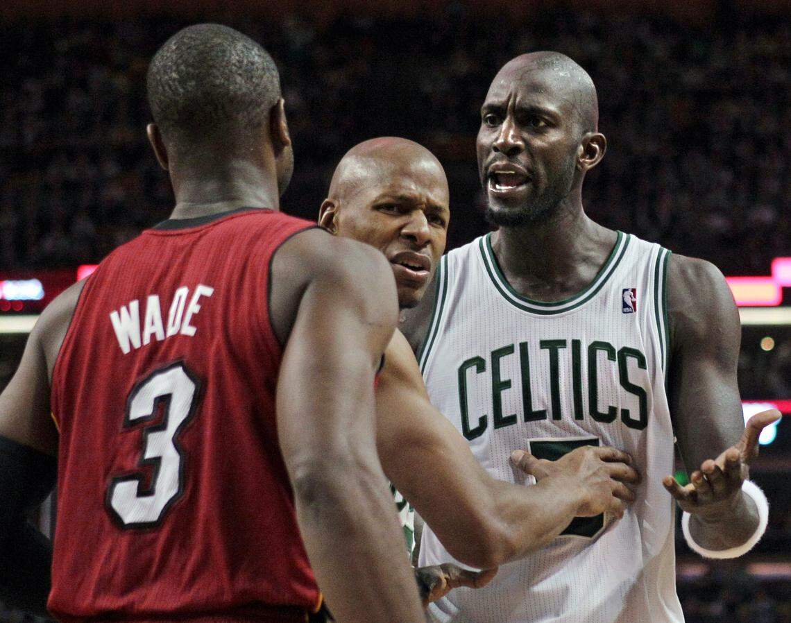 Boston Celtics forward Kevin Garnett, right, has words with Miami Heat guard Dwyane Wade (3) as Celtics’ Ray Allen gets between them in the second half of an NBA basketball game in Boston, Sunday, Feb. 13, 2011. The Celtics won 85-82.