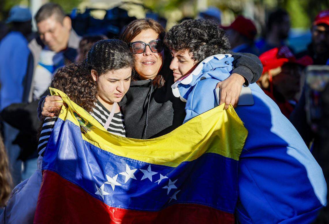 Camila Gonzalez, 18, and Matias Gonzalez, 16, hug their mother Jamila Briceno react to the news outside of El Arepazo in Doral, Florida, after the United States attacked Venezuela and captured Venezuelan leader Nicolás Maduro, on Saturday, January 3, 2026.