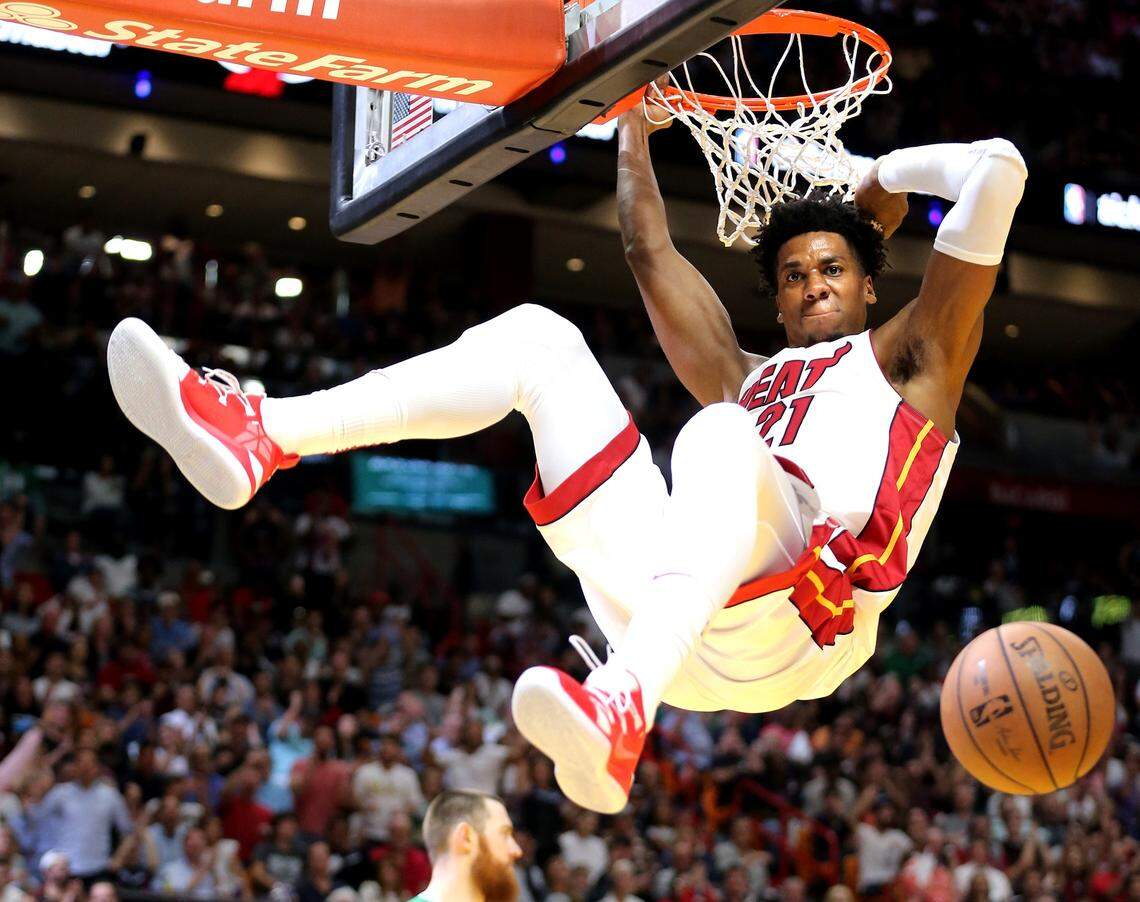 Miami Heat Hassan Whiteside (21) dunks the ball on a pass from Dwyane Wade in the fourth quarter as they play Boston Celtics at the AmericanAirlines Arena in Miami, Florida, Wednesday, April, 3, 2019.
