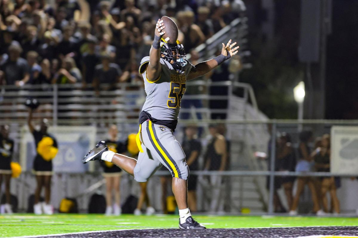American Heritage defensive tackle Omarian Abraham (56) reacts as he crosses the end zone for a touchdown against the St. John’s Cadets during the third quarter of a high school football game at American Heritage School in Plantation, Florida on Saturday, August 26, 2023.