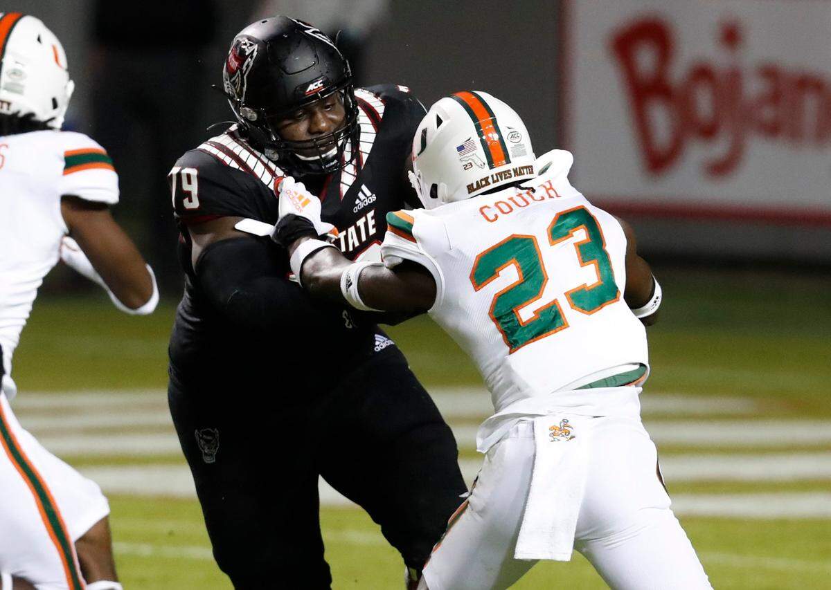 N.C. State offensive tackle Ikem Ekwonu (79) blocks Miami cornerback Te’Cory Couch (23) during the first half of N.C. States game against Miami at Carter-Finley Stadium in Raleigh, N.C., Friday, Nov. 6, 2020.