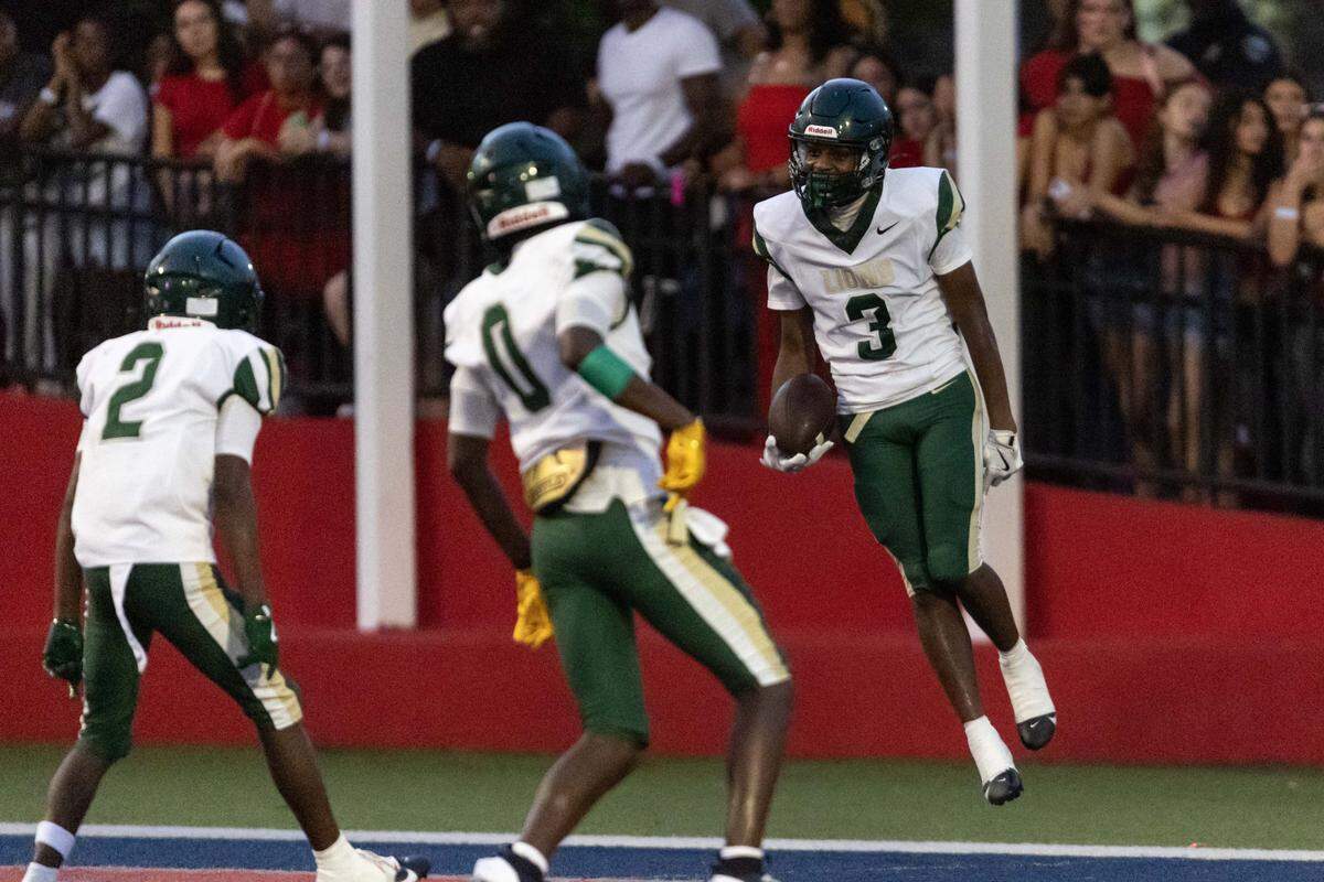 Mater Academy wide receiver Antonio Talton (3) reacts with teammates after scoring a touchdown during the first half of a high school football game at Doral Academy on Thursday, August 28, 2025, in Doral, Fla.