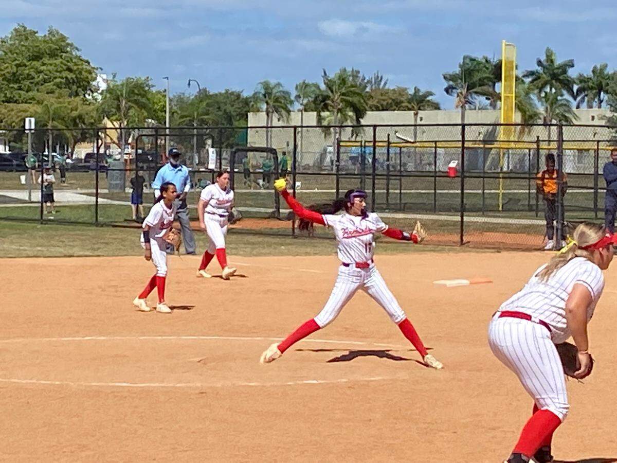 Doral Academy’s Yessenia Lopez pitches against Coral Springs Charter as her teammates prepare to defend during a game of the Orange Bowl Florida Fastpitch Invitational.