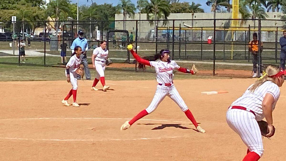 Doral Academy’s Yessenia Lopez pitches against Coral Springs Charter as her teammates prepare to defend during a game of the Orange Bowl Florida Fastpitch Invitational.