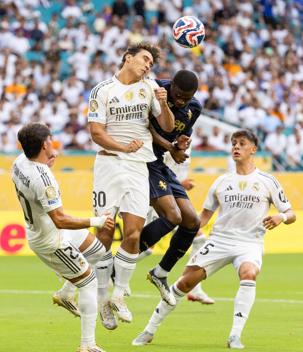 Real Madrid CF forward Gonzalo Garcia (30) and Juventus forward Randal Kolo Muani (20) fight for a header in the first half of their round of 16 FIFA Club World Cup soccer match at Hard Rock Stadium on Tuesday, July 1, 2025, in Miami Gardens, Fla.