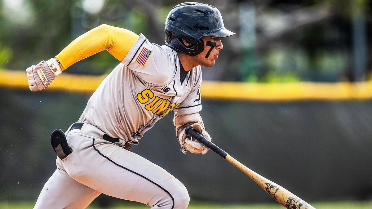 Miami Sunset’s Angel Santiago (2) runs after getting a hit in the first inning of a GMAC Tournament game against the Felix Varela Vipers at Felix Varela Senior High.